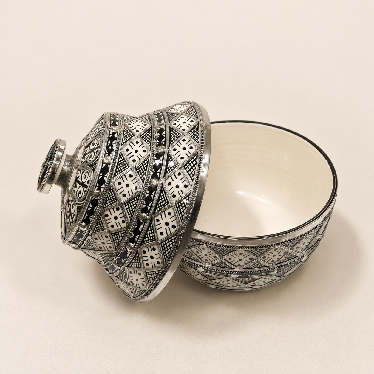 Black and white vessel with lid removed.