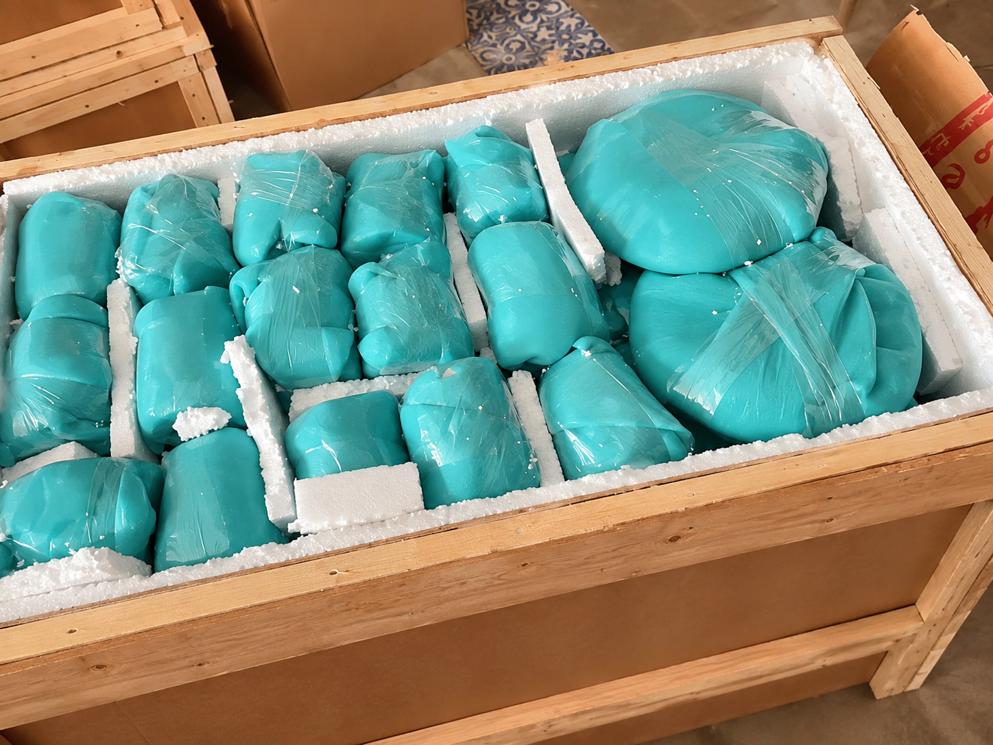 Ceramic forms carefully wrapped and packed inside a protective crate.