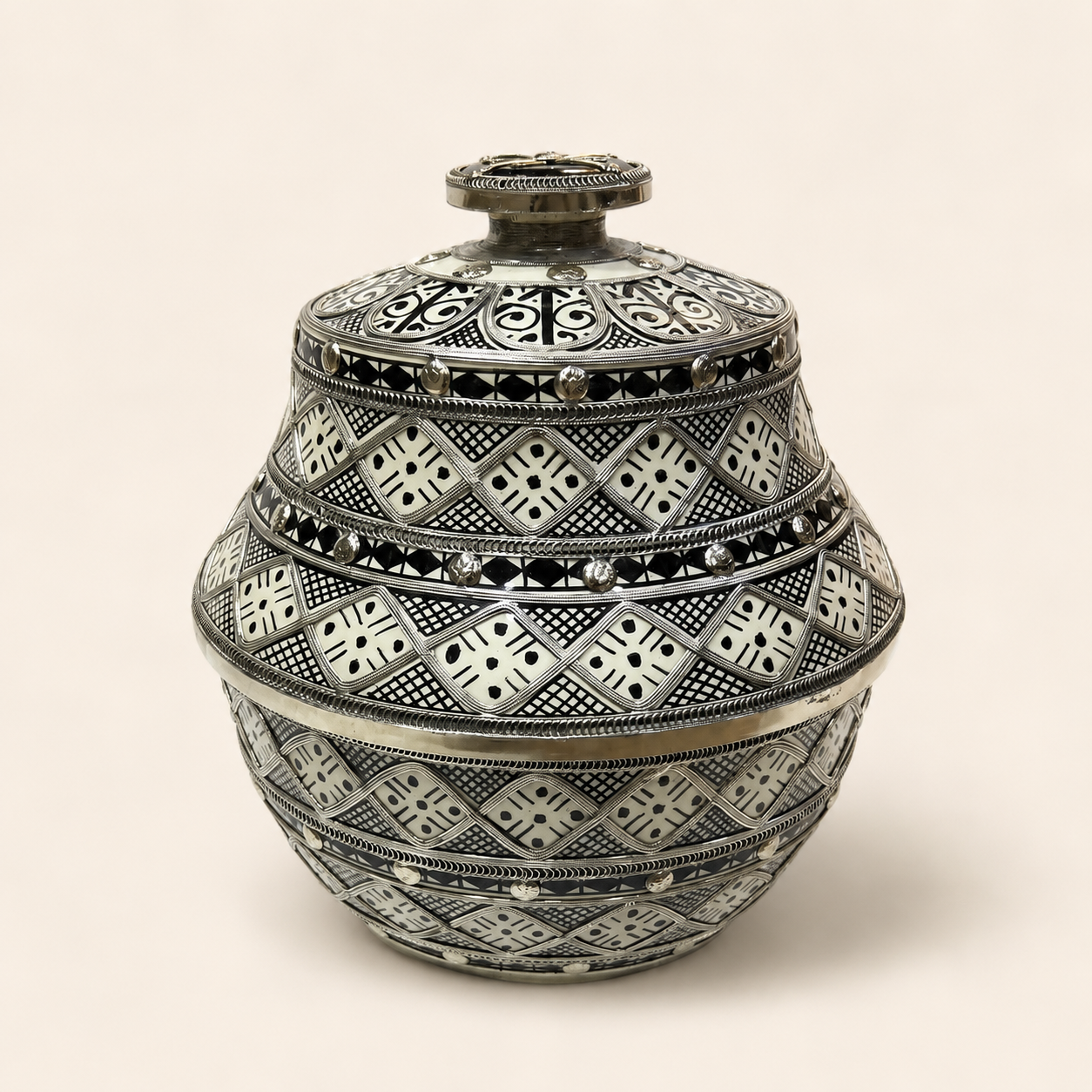 Black and white geometric lidded vessel, closed.